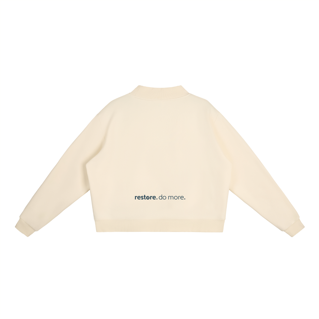Beige sweater with 'restore.do more.' text on a white background